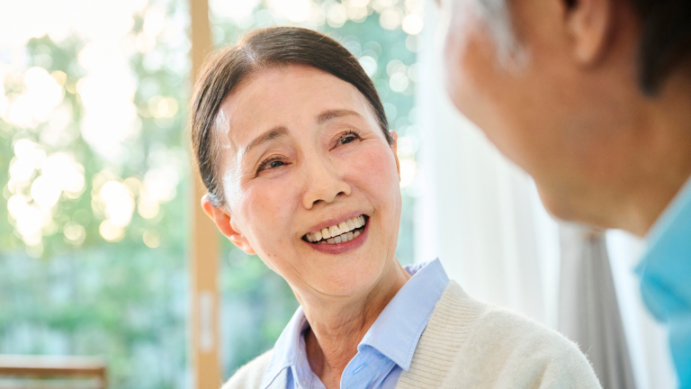 Elderly woman smiling at man