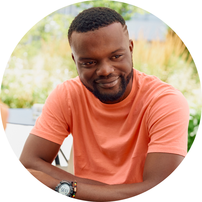 Man in orange t-shirt smiling Man in orange t-shirt smiling